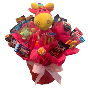 Pink Giraffe in a metal tin surrounded by chocolate and lollies