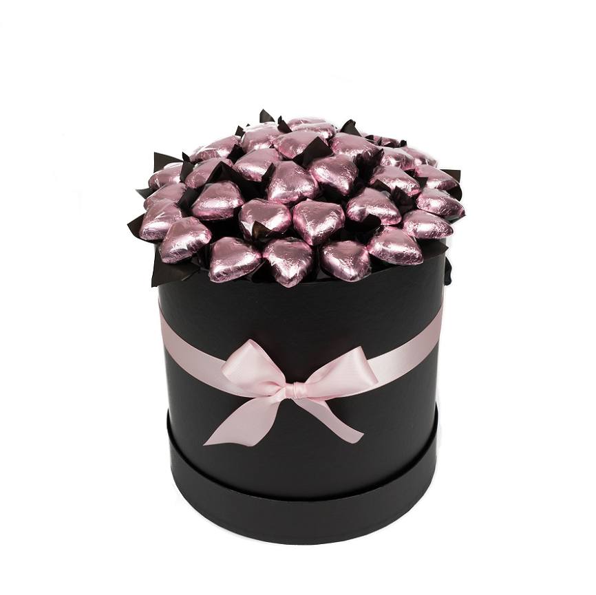 Pink foiled Belgian chocolate hearts presented in a black hat box with a pink ribbon