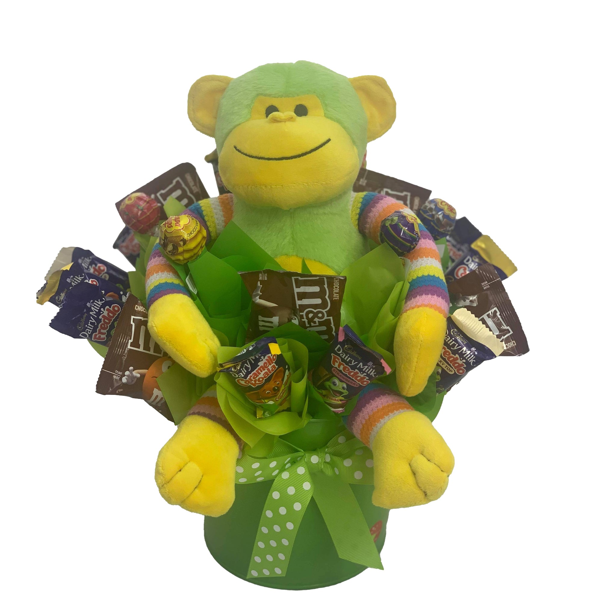 Blue Monkey in a metal tin surrounded by chocolate and lollies